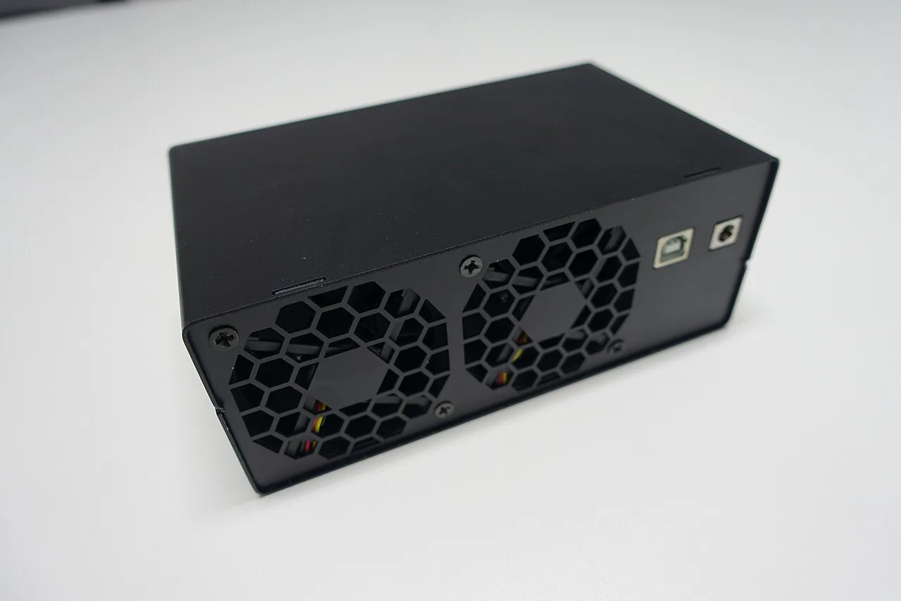 Single entry-level black ASIC miner with a large cooling fan and cyan status lighting