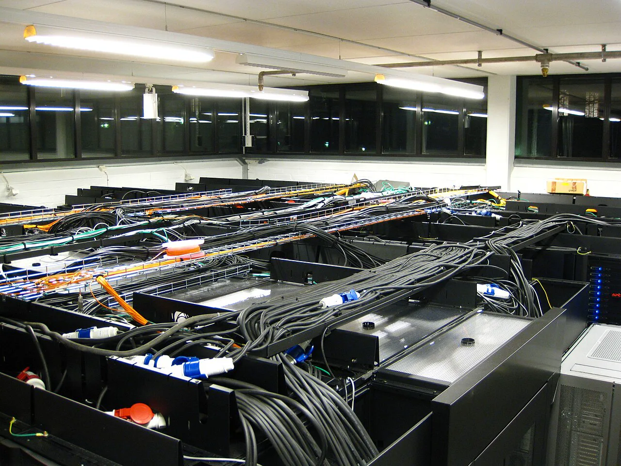 Long professional Bitcoin mining farm aisle with dense computing infrastructure